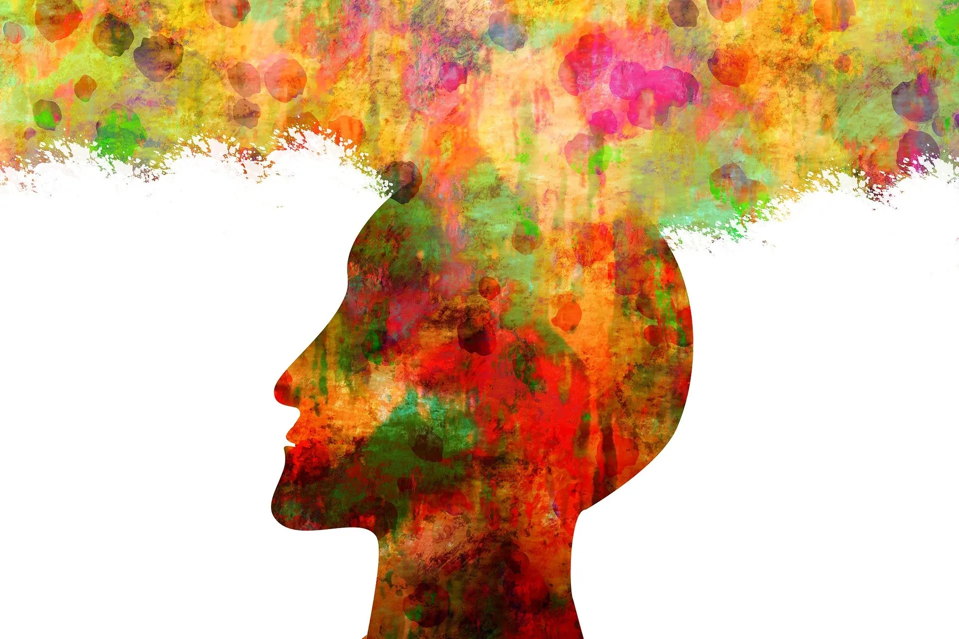 Profile silhouette of a head filled with red, orange, green and pink paint splashes that spread out above it